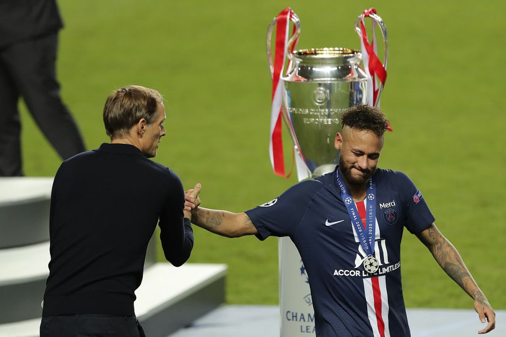 PSG's head coach Thomas Tuchel, left, shake hands with PSG's Neymar after the Champions League final soccer match between Paris Saint-Germain and Bayern Munich at the Luz stadium in Lisbon, Portugal, Sunday, Aug. 23, 2020. (Miguel A. Lopes/Pool via AP)