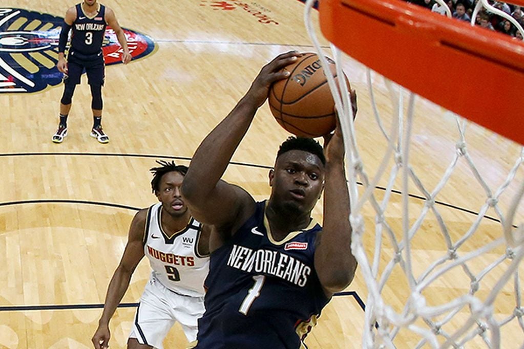 NEW ORLEANS, LOUISIANA - JANUARY 24: Zion Williamson #1 of the New Orleans Pelicans shoots over Gary Harris #14 of the Denver Nuggets during a NBA game at Smoothie King Center on January 24, 2020 in New Orleans, Louisiana. NOTE TO USER: User expressly acknowledges and agrees that, by downloading and or using this photograph, User is consenting to the terms and conditions of the Getty Images License Agreement.   Sean Gardner/Getty Images/AFP
== FOR NEWSPAPERS, INTERNET, TELCOS & TELEVISION USE ONLY ==