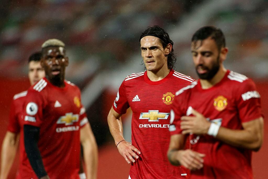 Manchester United's Edinson Cavani, centre, Bruno Fernandes, right, and Paul Pogba react during the English Premier League soccer match between Manchester United and Chelsea, at the Old Trafford stadium in Manchester, England, Saturday, Oct. 24, 2020. (Phil Noble/Pool via AP)