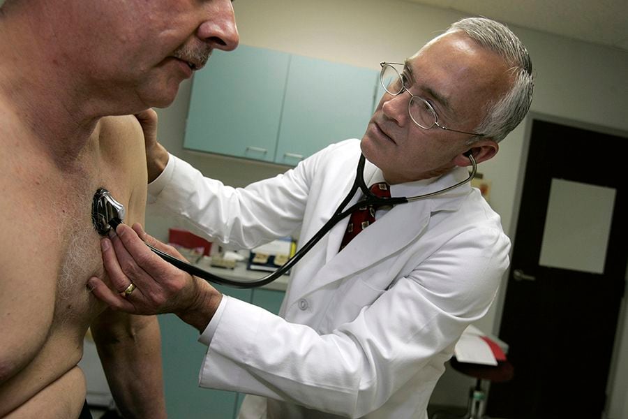 Dr. John Dunlap gives an annual physical examination to Chuck Wiedenh