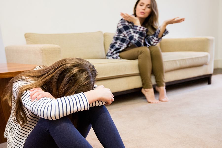 Mother shouting at her daughter in living room