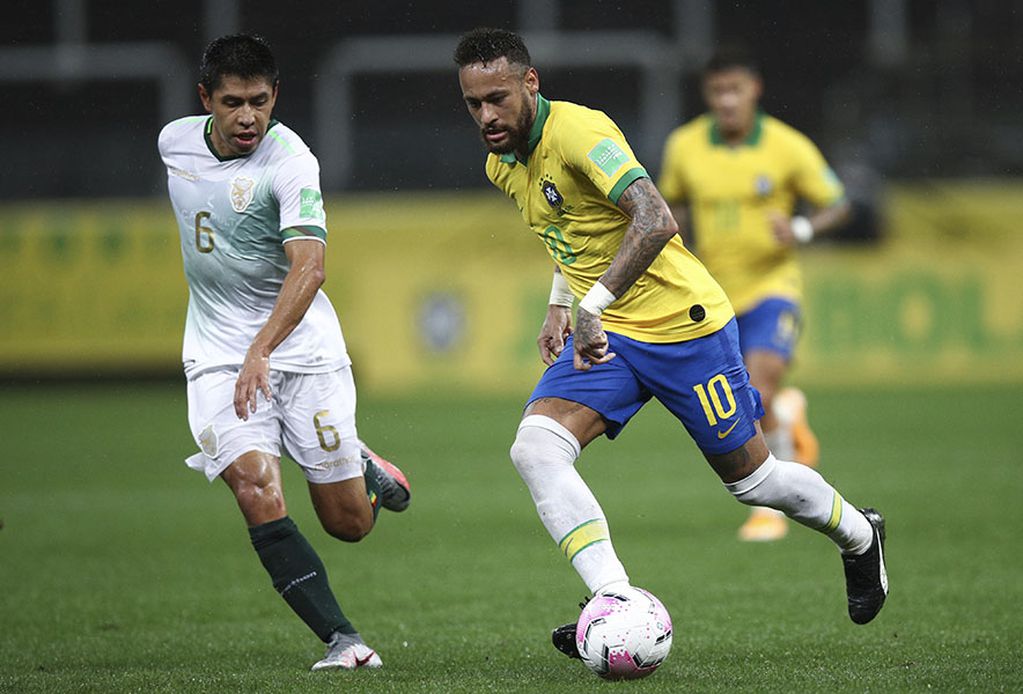 Brazil's Neymar, right, runs with the ball as Bolivia's Diego Wayar challenges him during a qualifying soccer match for the FIFA World Cup Qatar 2022 at the Neo Quimica arena in Sao Paulo, Brazil, Friday, Oct. 9, 2020. (Buda Mendes/Pool via AP)