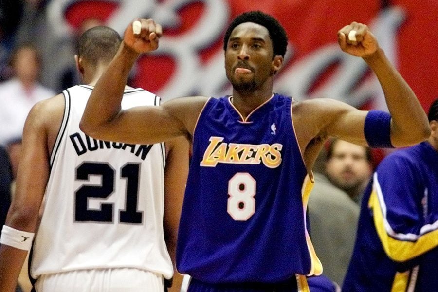 FILE PHOTO: Los Angeles Lakers guard Kobe Bryant celebrates while San Antonio Spurs forward Tim Duncan walks off disconsolately during Game 2 of the Western Conference Finals at the Alamodome in San Antonio.