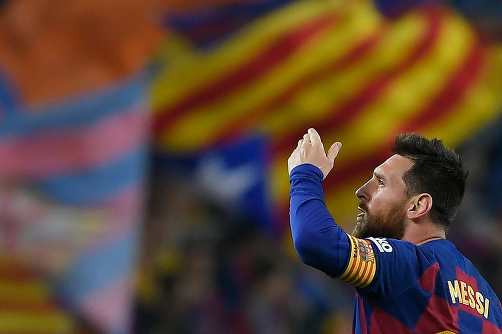 (FILES) In this file photo taken on October 29, 2019 Barcelona's Argentine forward Lionel Messi celebrates his goal during the Spanish league football match between FC Barcelona and Real Valladolid FC at the Camp Nou stadium in Barcelona. - Lionel Messi confirmed on September 4, 2020 he will stay at Barcelona, insisting he could never go to court against "the club of his life". Messi released a statement at 6pm CET, saying "I would never go to court against Barca because it is the club that I love, that gave me everything since I arrived, it is the club of my life, I have made my life here." (Photo by LLUIS GENE / AFP)