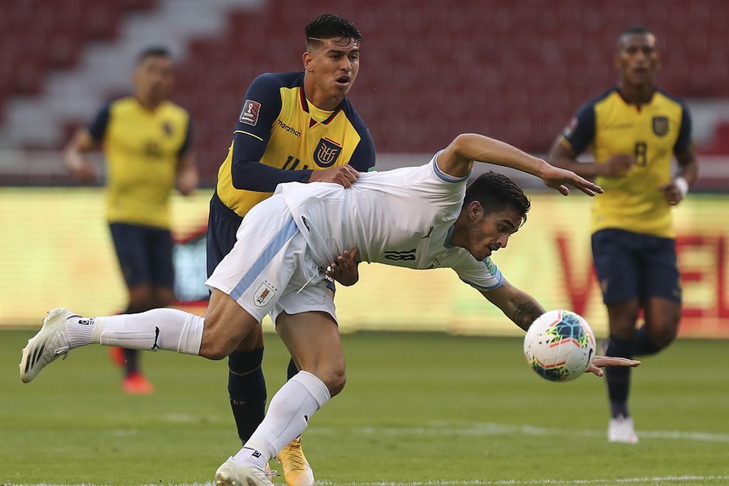 Uruguay's Maximiliano Gomez, right. fights for the ball with Ecuador's Xavier Arreaga during a qualifying soccer match for the FIFA World Cup Qatar 2022 at the Casa Blanca stadium in Quito, Ecuador, Tuesday, Oct. 13, 2020. (Jose Jacome/Pool via AP)