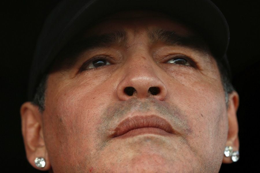 FILE PHOTO: Former Argentina captain and coach Maradona watches the Primera D championship soccer match between Deportivo Riestra and San Miguel in Buenos Aires