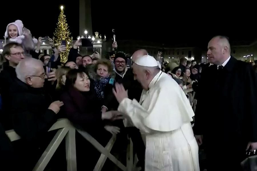 Pope Francis slaps the hand of a woman who grabbed him, at Saint Peter's Square at the Vatican