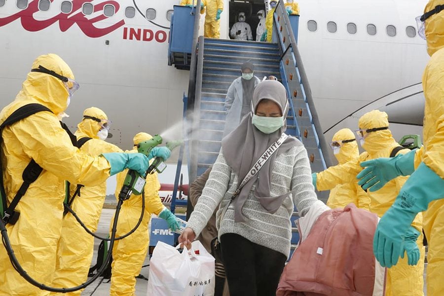 Medical officers prepare evacuated Indonesian nationals from Wuhan, China's center of the coronavirus epidemic, before transferring them to the Natuna Islands military base to be quarantined, at Hang Nadim Airport in Batam, Riau Islands